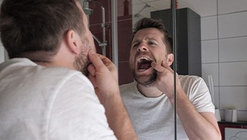 Patient looking at mouth in mirror