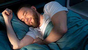 a man smiling while getting good rest