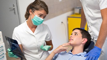 Patient smiling at dentist after oral cancer screening