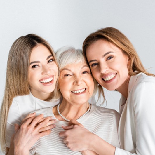 a mature woman with All-On-4 smiling with family