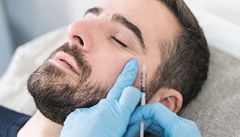 a person receiving BOTOX injections to get rid of crow’s feet