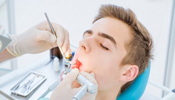 Person receiving a teeth cleaning in Brick