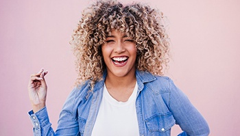 smiling woman after learning what a cosmetic dentist in Brick Township can do