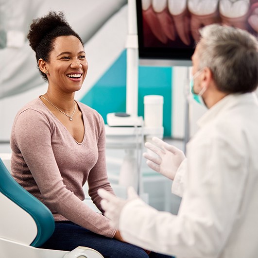 Woman smiling while talking to cosmetic dentist in Brick Township