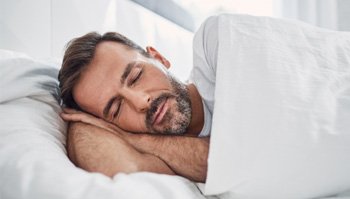 Man sleeping in a bed