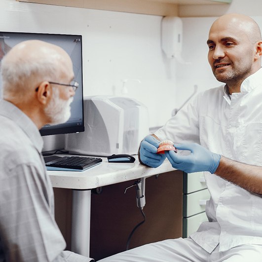 Dentist in Brick Township speaking with a patient about dentures