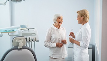 a patient laughing and smiling with her dentist