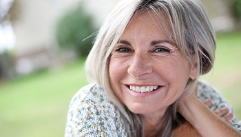 a woman smiling with dentures in Brick Township