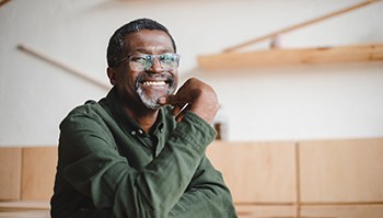 a man smiling after replacing missing teeth in Brick Township