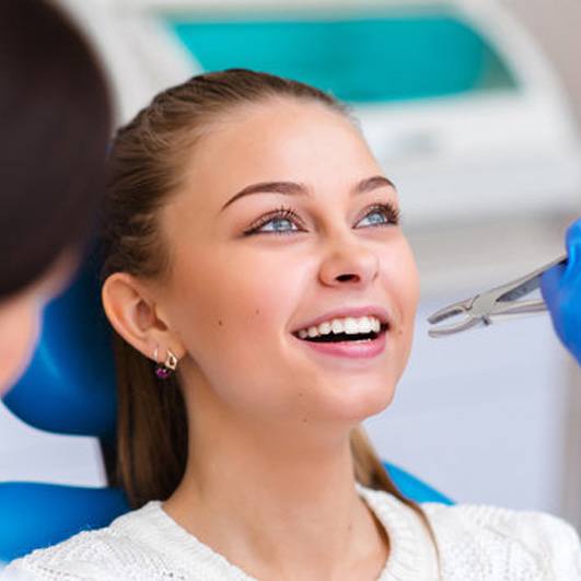 a patient visiting her dentist for tooth extractions 