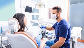 Implant dentist in Brick Township speaking with a patient