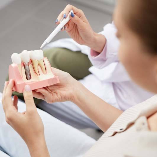 Patient learning about dental implants in Brick Township