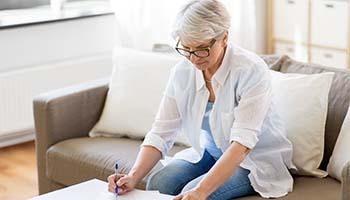 Woman researching how to pay for dental implants in Brick Township