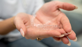 Patient holding clear aligner