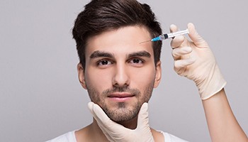 a person receiving a dermal filler injection in their forehead