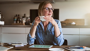 a person relaxing and drinking a cup of coffee