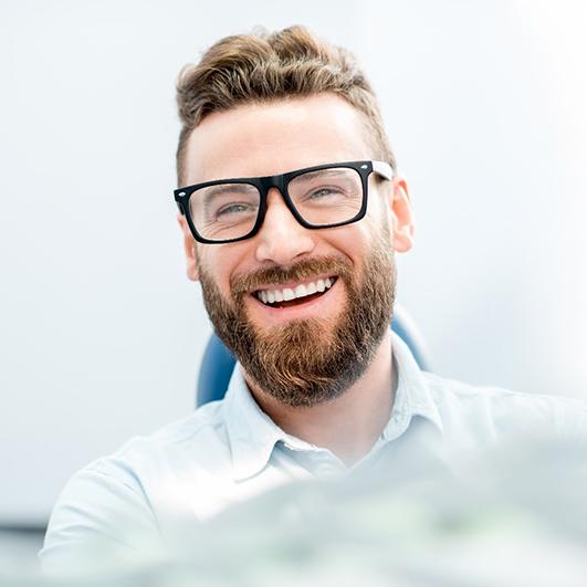 man smiling after getting smile makeover in Brick Township