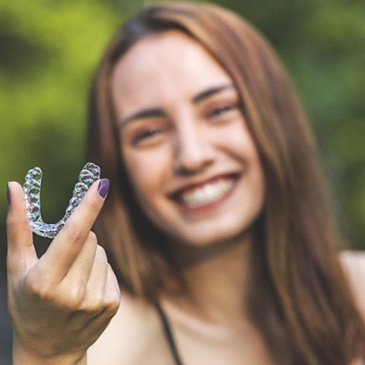 Happy woman enjoying benefits of NU Smile Aligners