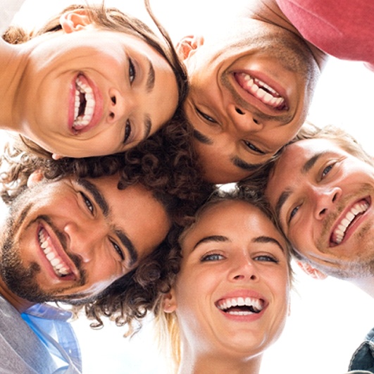 Group of smiling friends with attractive, straight teeth