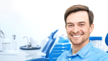 Man smiling in dental chair before oral conscious sedation in Brick Township, NJ