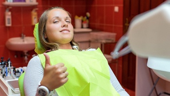 Female patient giving thumbs up before oral conscious sedation in Brick Township, NJ