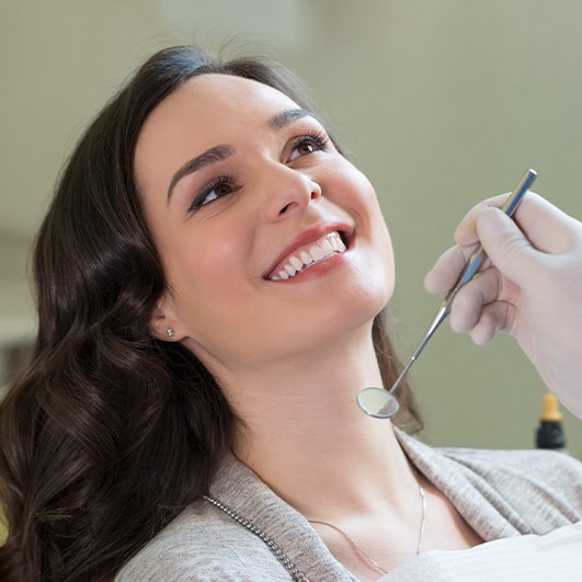 Woman receiving preventive dentistry exam