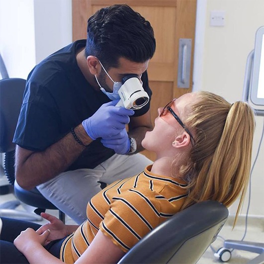 Woman receiving oral cancer screening