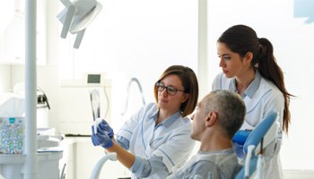 a dentist explaining the root canal process in Brick Township