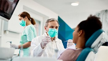 a dentist preparing to check a patient’s oral health