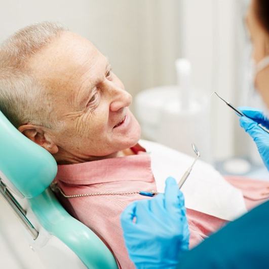 a patient talking to front desk about cost of treatment