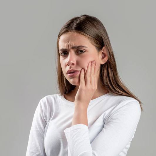 Concerned woman touching side of her face