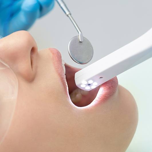 Dentist capturing picture with intraoral camera