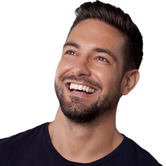 Smiling, handsome young man with well-made porcelain veneers