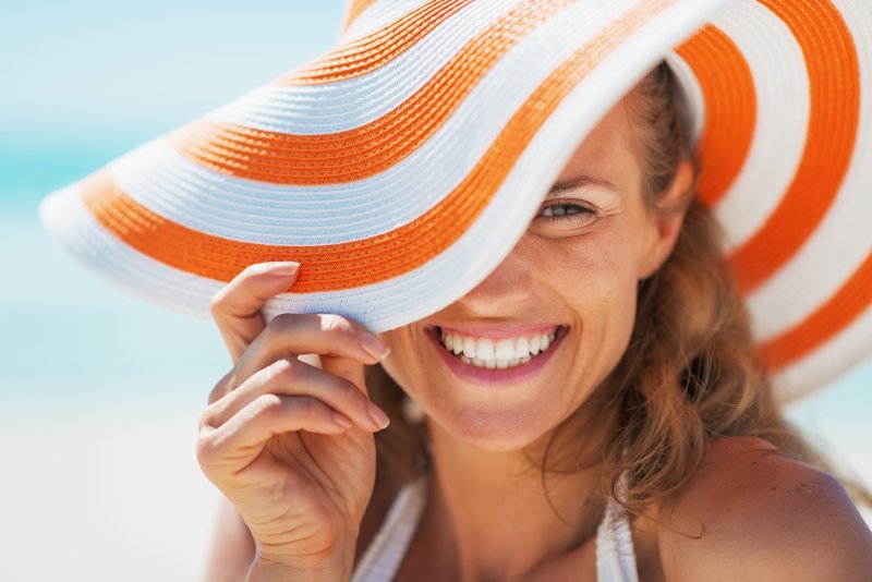 Happy young woman in beach hat.