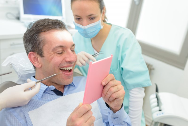 A man smiling after his cosmetic dentistry treatments