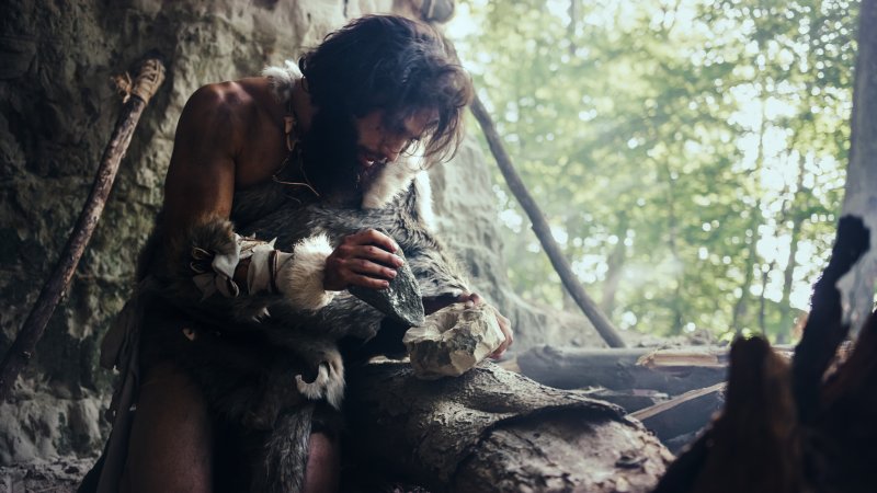 Early man with wisdom teeth making a bowl for food 